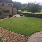 Large landscaped lawn with sweeping gravel path